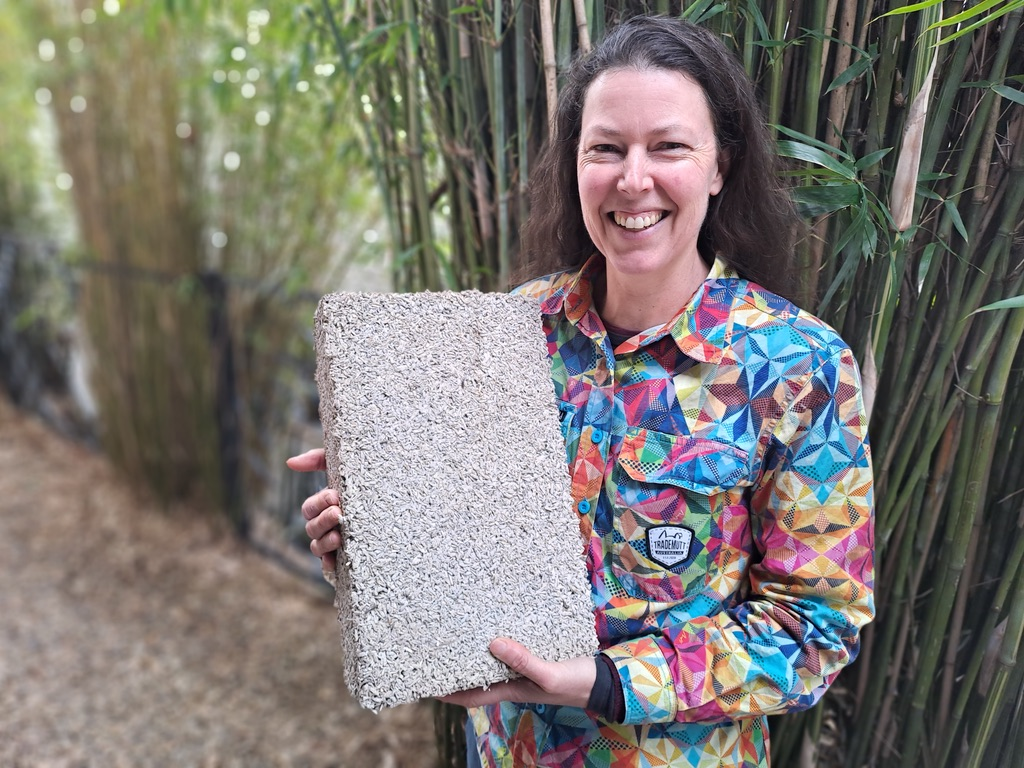 Kirstie Wulf of Shelter Building Design holding a hempcrete block (Photo: Belle Butler